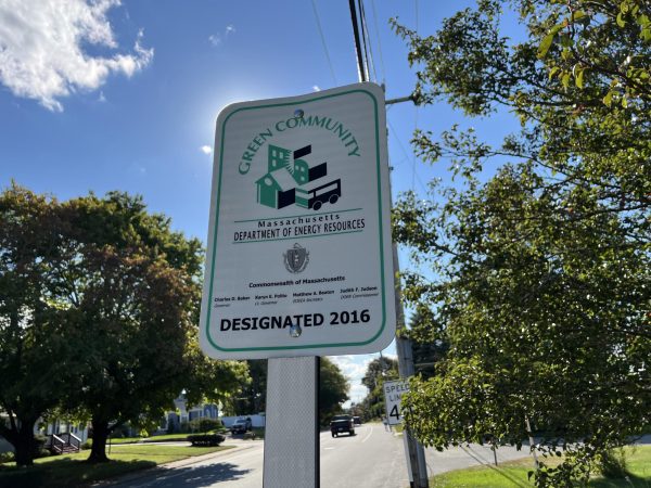 A sign on the Dartmouth town line, recognizing the town's status as a Green Community.